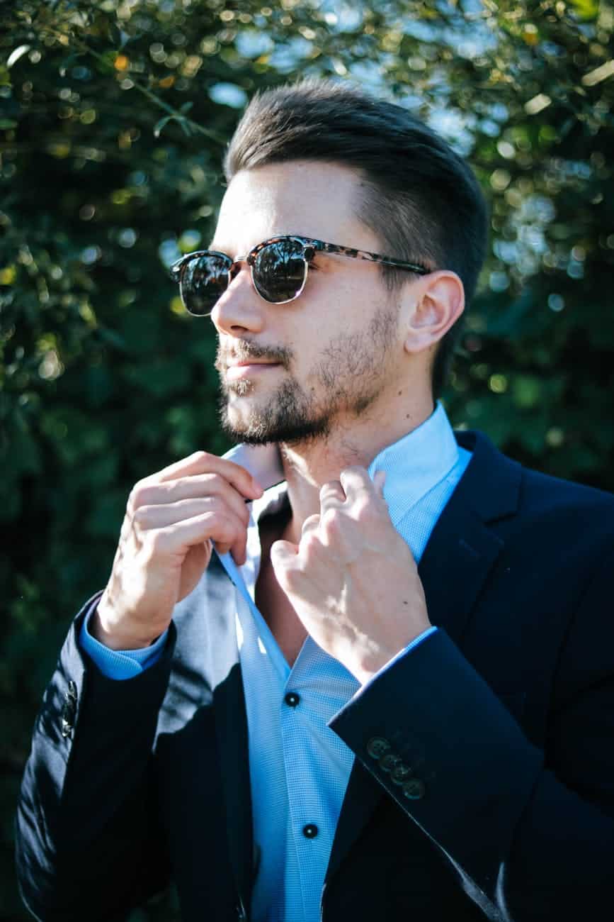 man in blue dress shirt and black formal suit