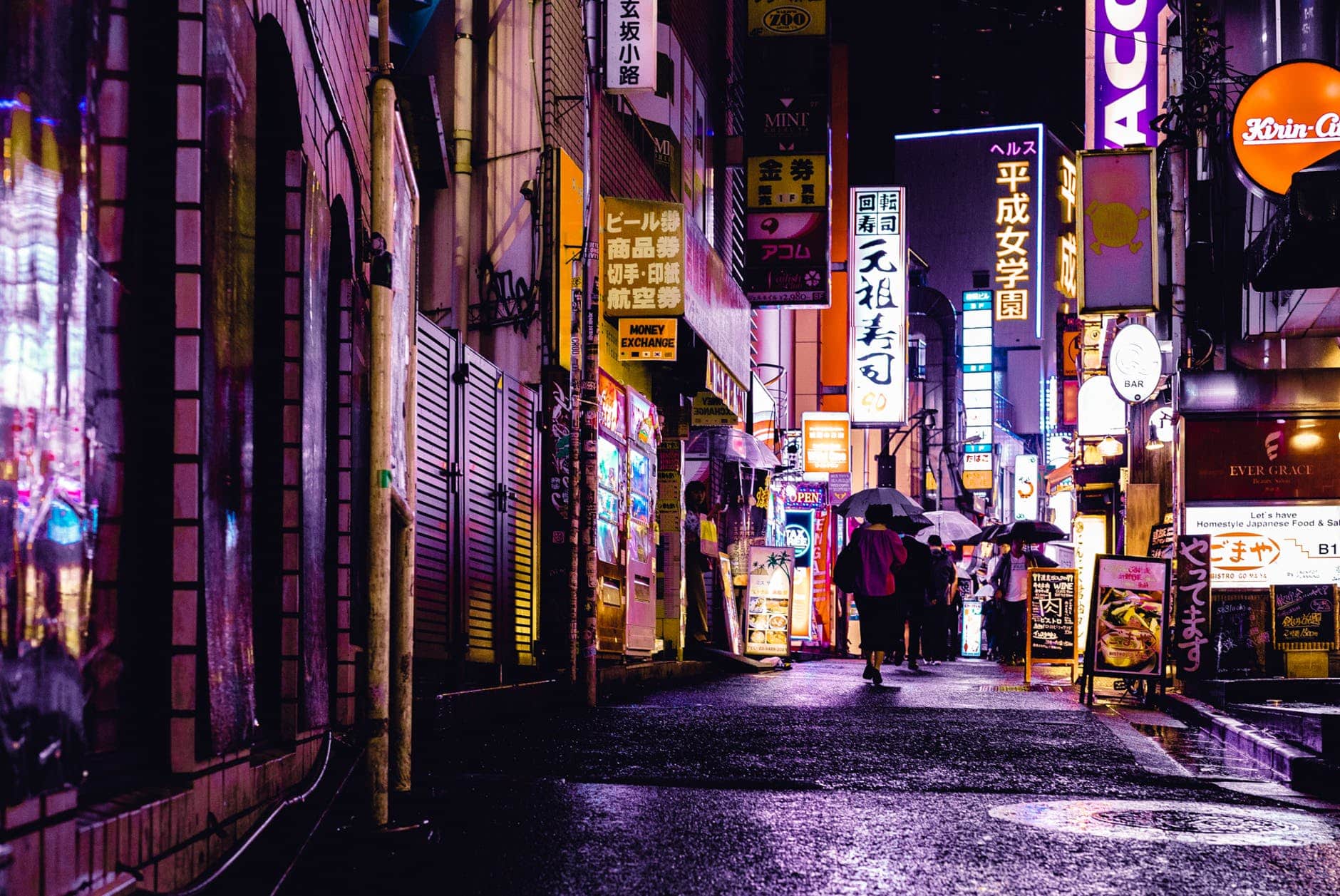 woman walking in the street during night time