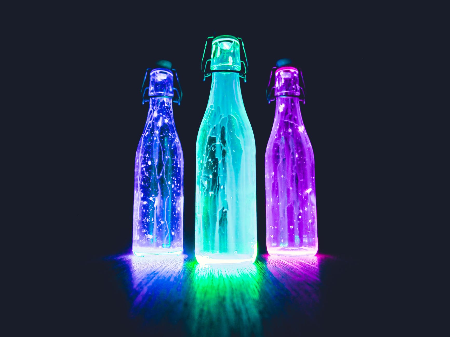 three lighted bottles