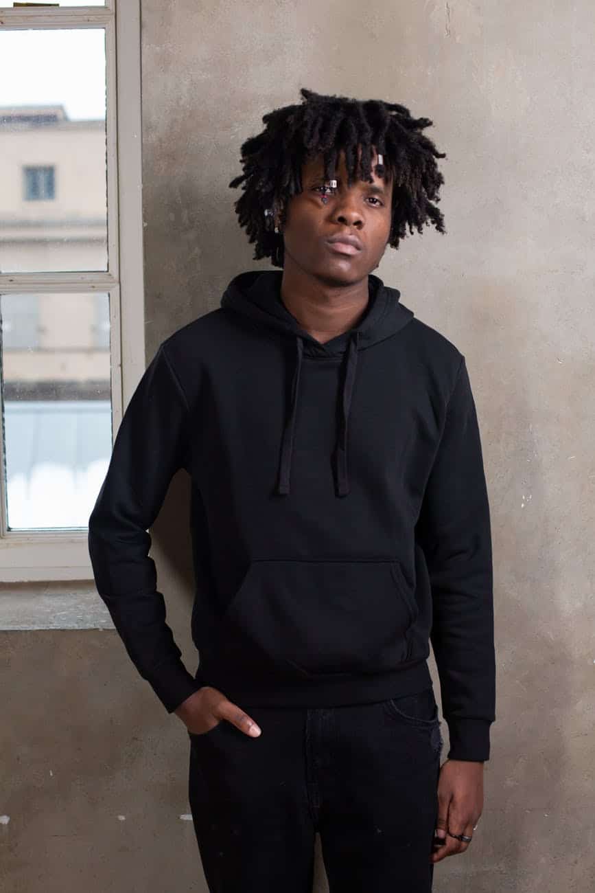 young black man with hand in pocket in stylish sportswear