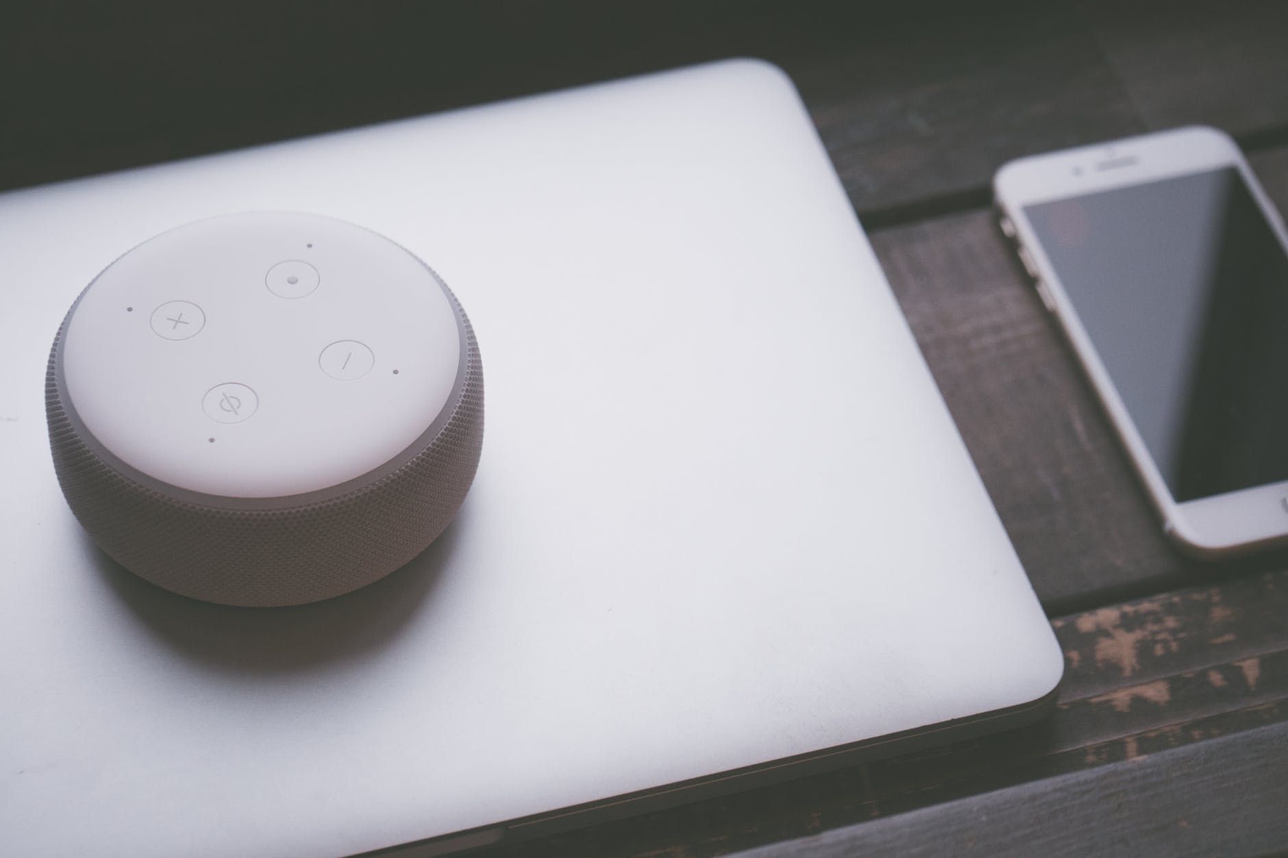 white bluetooth speaker on silver laptop computer