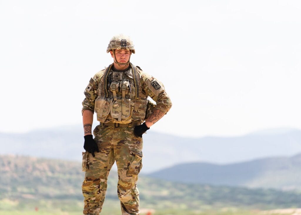 unarmed us soldier in field camo uniform with mountains in background