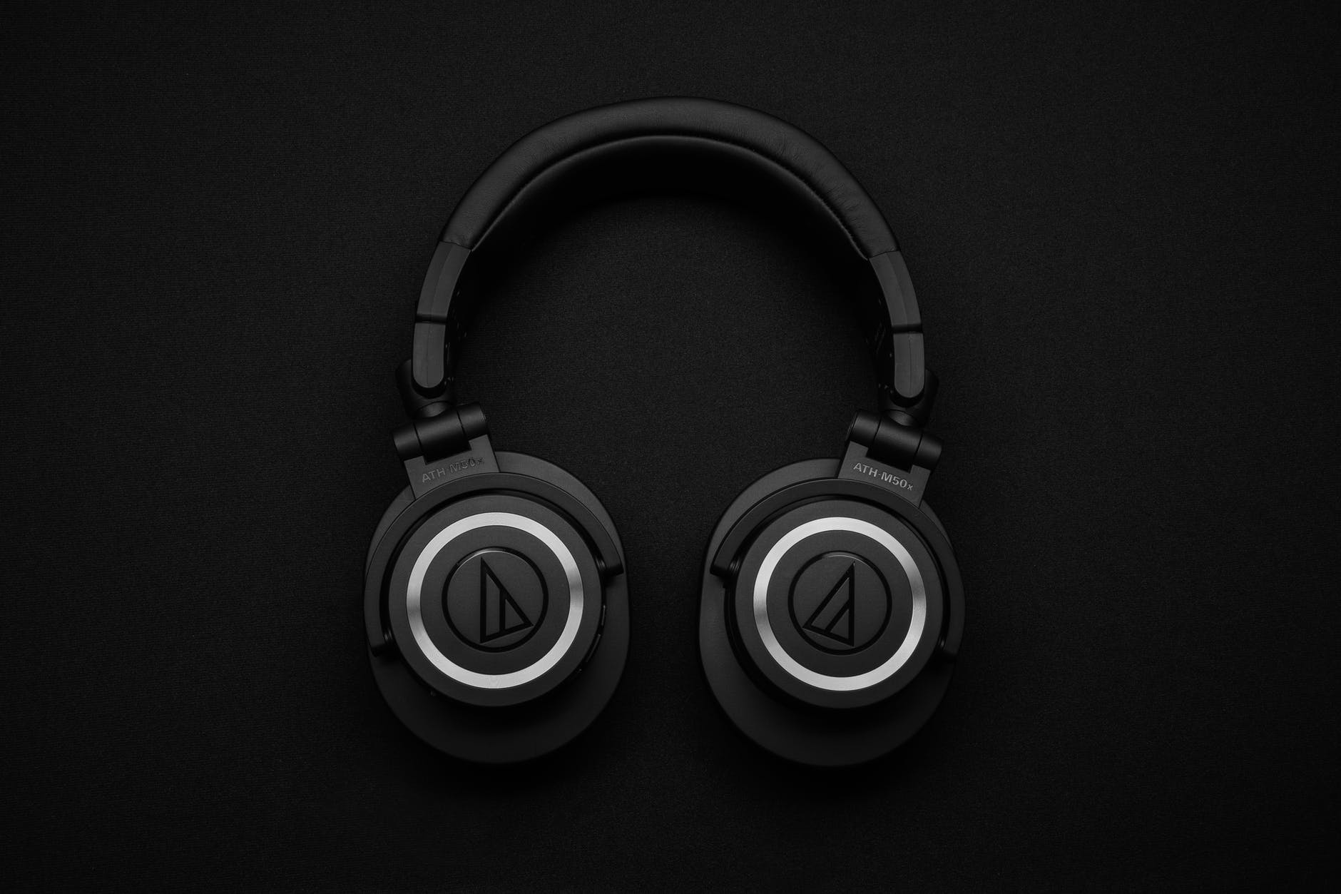 top view photo of black wireless headphones