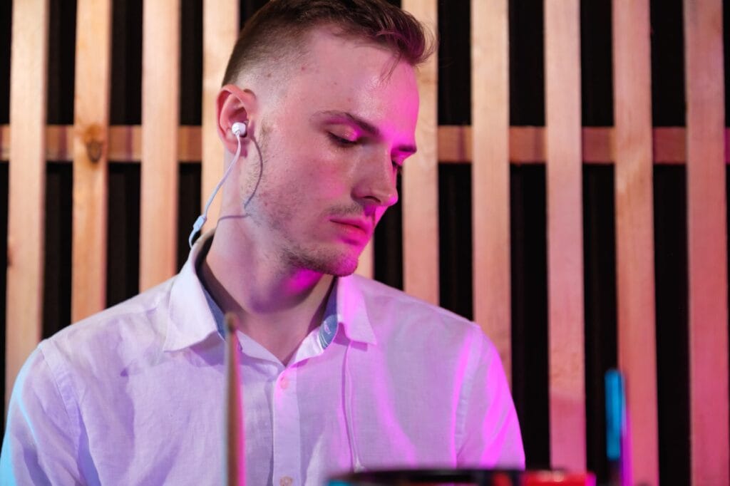 close up photo of white dress shirt wearing earphones