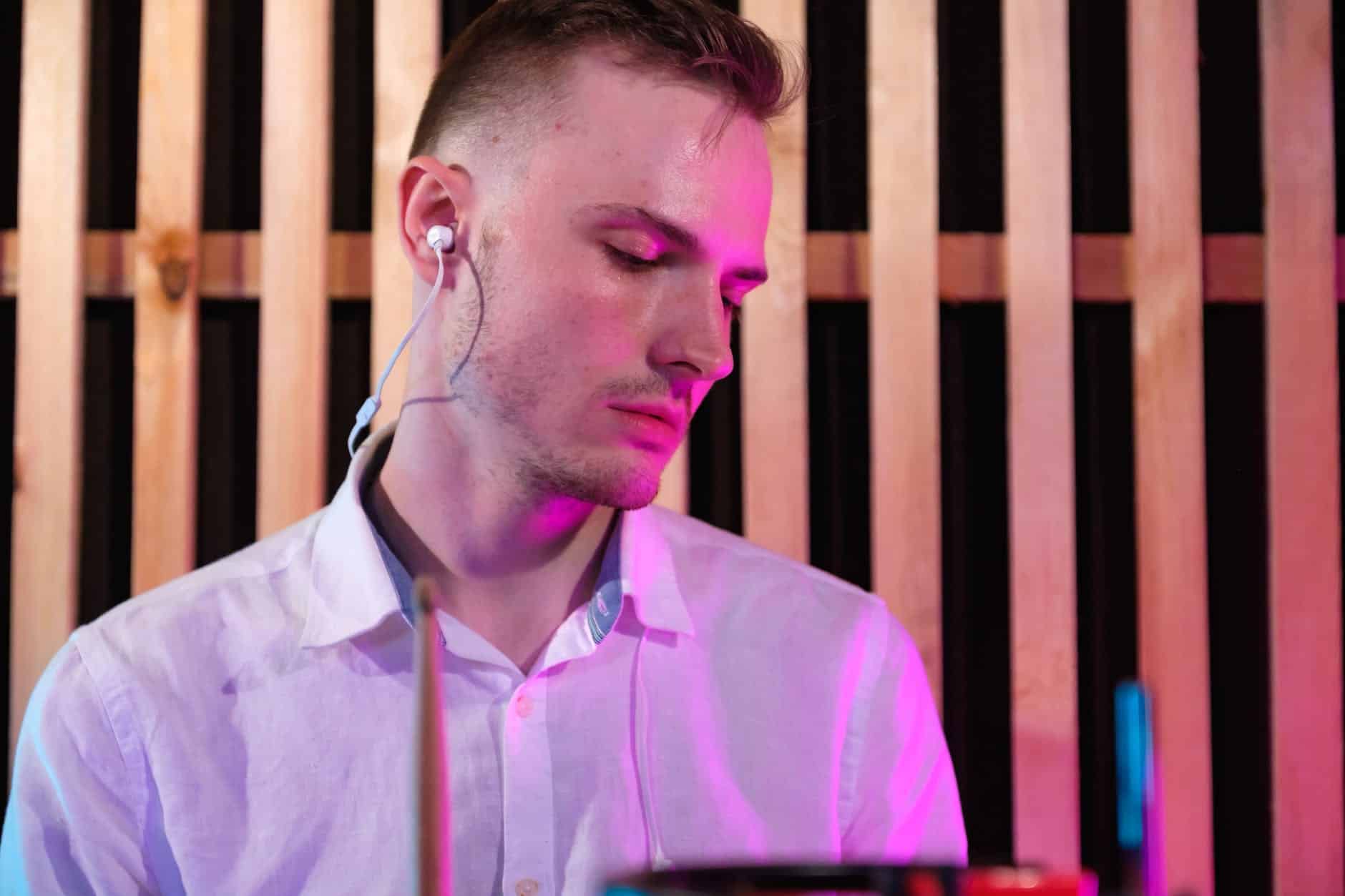 close up photo of white dress shirt wearing earphones