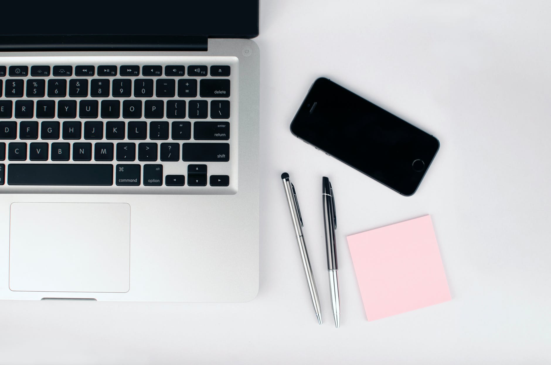 two pens beside macbook