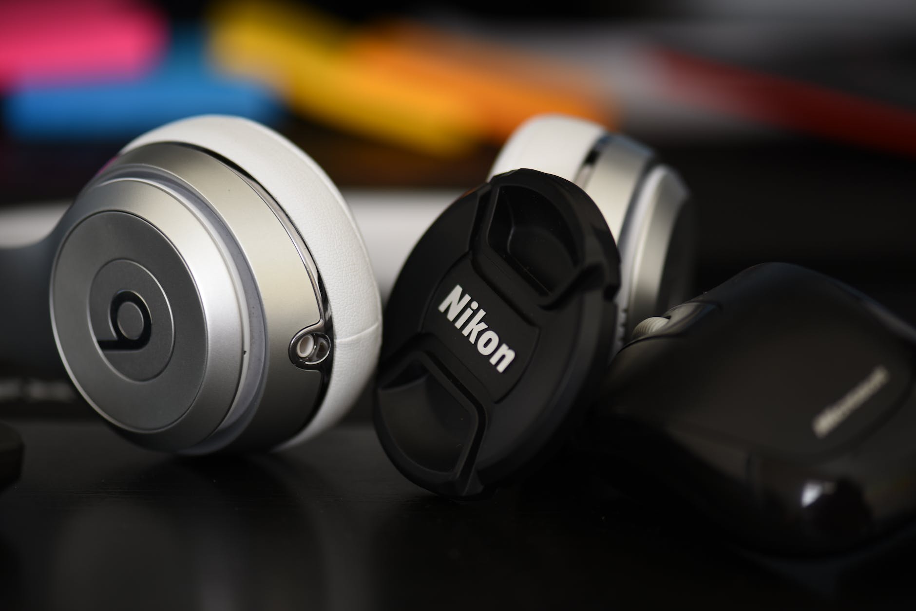 silver beats by dr dre studio and nikon camera lens cover