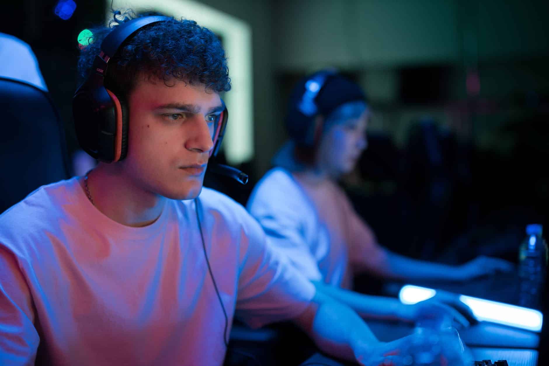 man with curly hair wearing black headset