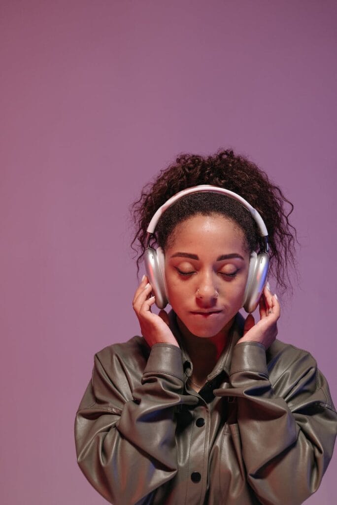 woman in gray dress shirt wearing headphones