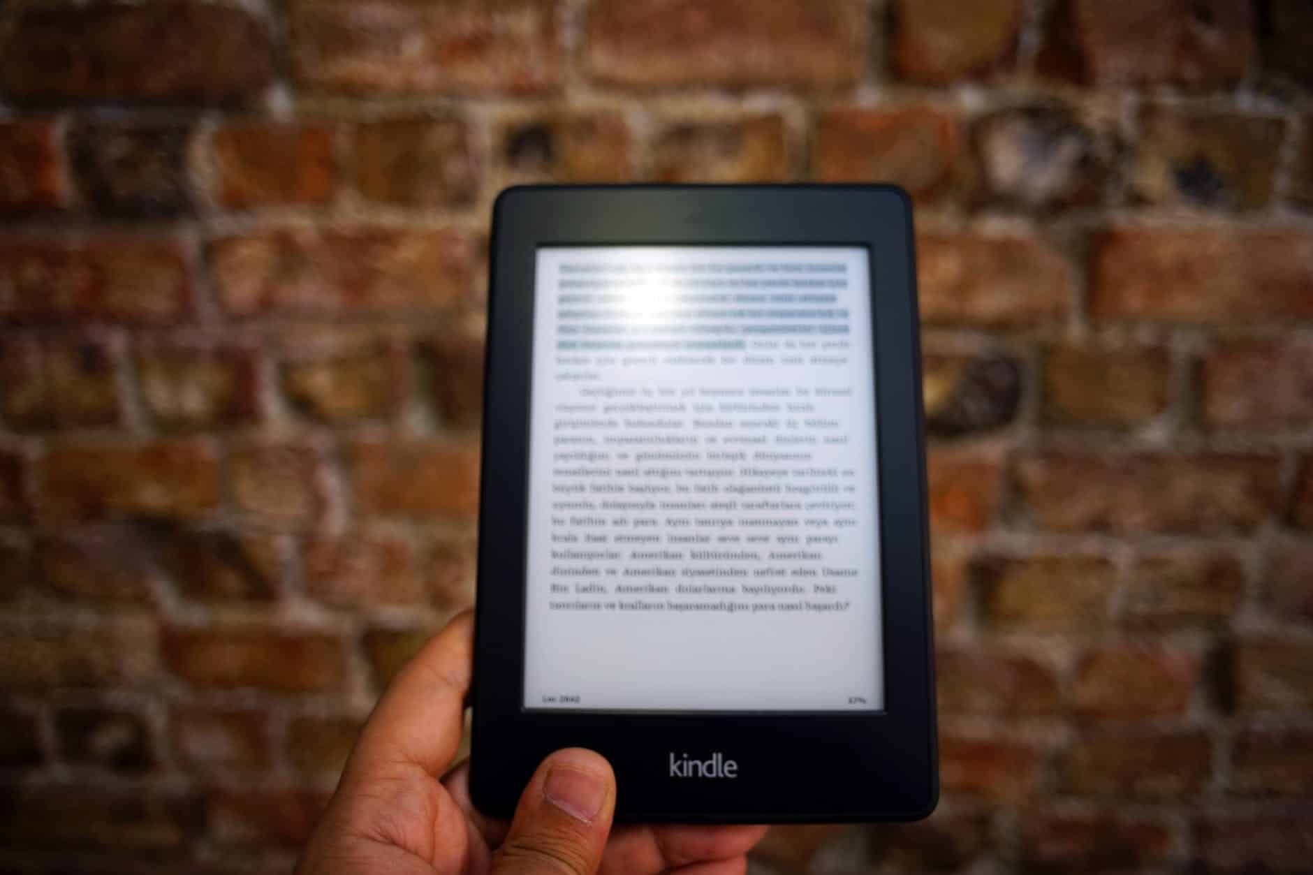 person holding amazon kindle ebook