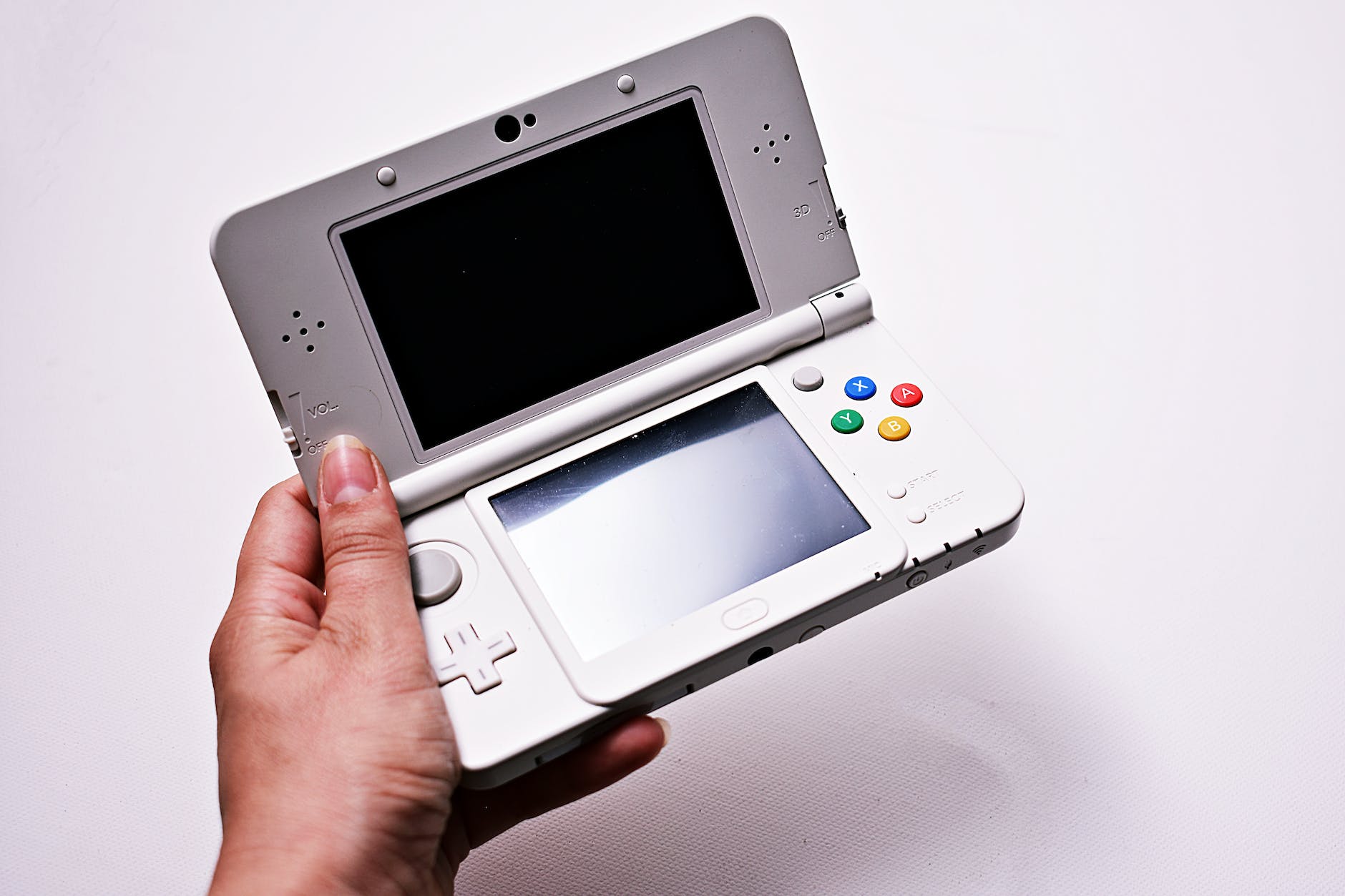 person holding gray nintendo gameboy advance