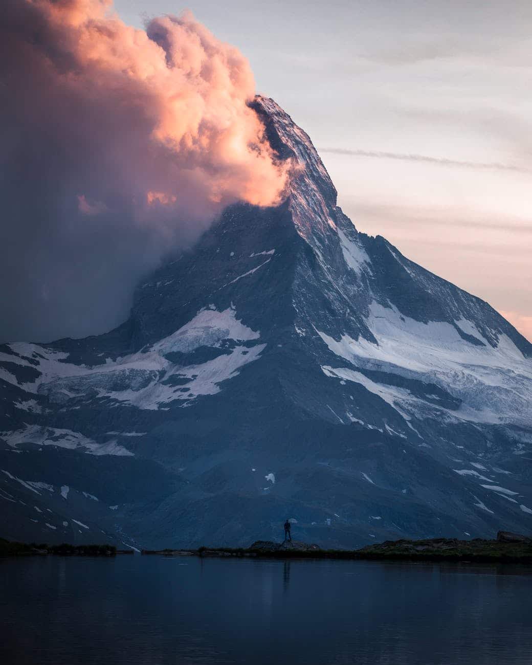 photo of person standing across the mountain